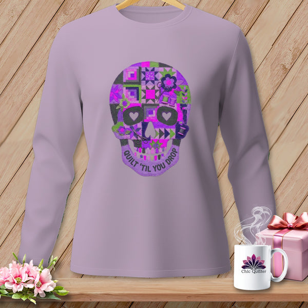 Lavender long-sleeve shirt with a quilted skull graphic and text "QUILT 'TIL YOU DROP".