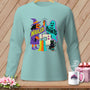 Light blue long sleeve shirt with witch, ghost, sewing machine, and black cat Halloween graphic.
