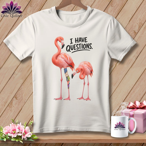 White t-shirt with two pink flamingos and text "I HAVE QUESTIONS."