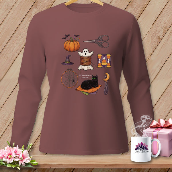 Halloween-themed sewing graphic with pumpkin, ghost, cat, and scissors on a maroon long-sleeved shirt.