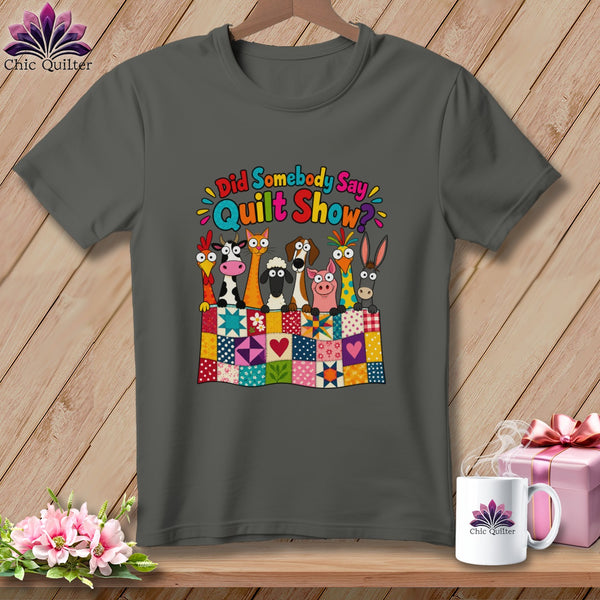 Dark gray t-shirt with a cartoon graphic of farm animals behind a colorful quilt and the text Did Somebody Say Quilt Show.