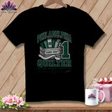 A black t-shirt hangs on a wooden hanger, featuring green text reading Philadelphia Quilter and a graphic of fabric bolts in a crate.