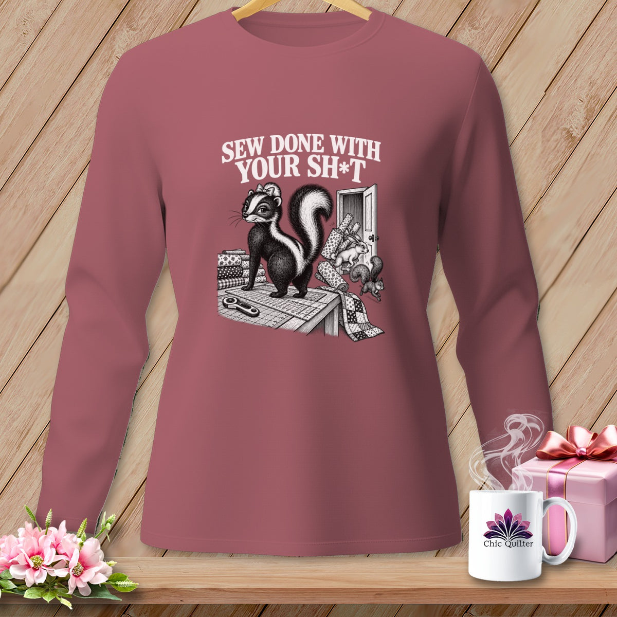 Long-sleeve shirt with a skunk design and text "SEW DONE WITH YOUR SH*T."
