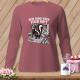 Long-sleeve shirt with a skunk design and text 