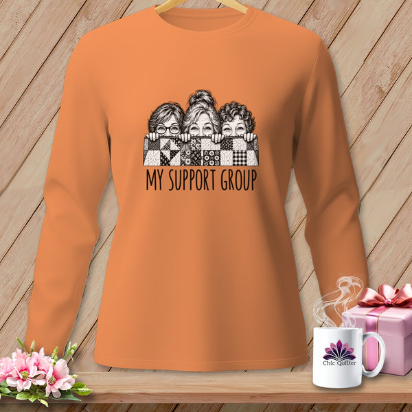 Orange long-sleeve shirt with three women peeking over a quilt pattern that reads "MY SUPPORT GROUP".