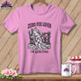 Pink t-shirt with a fox relaxing in a chair, sewing machine, and the text "ZERO FOX GIVEN I'M QUILTING".
