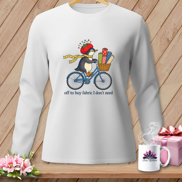 Penguin on bicycle with fabric rolls, "off to buy fabric I don't need."