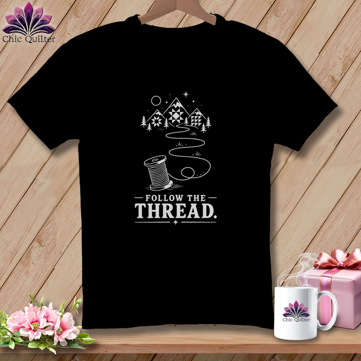 Black t-shirt with "Follow The Thread" text and sewing spool design.