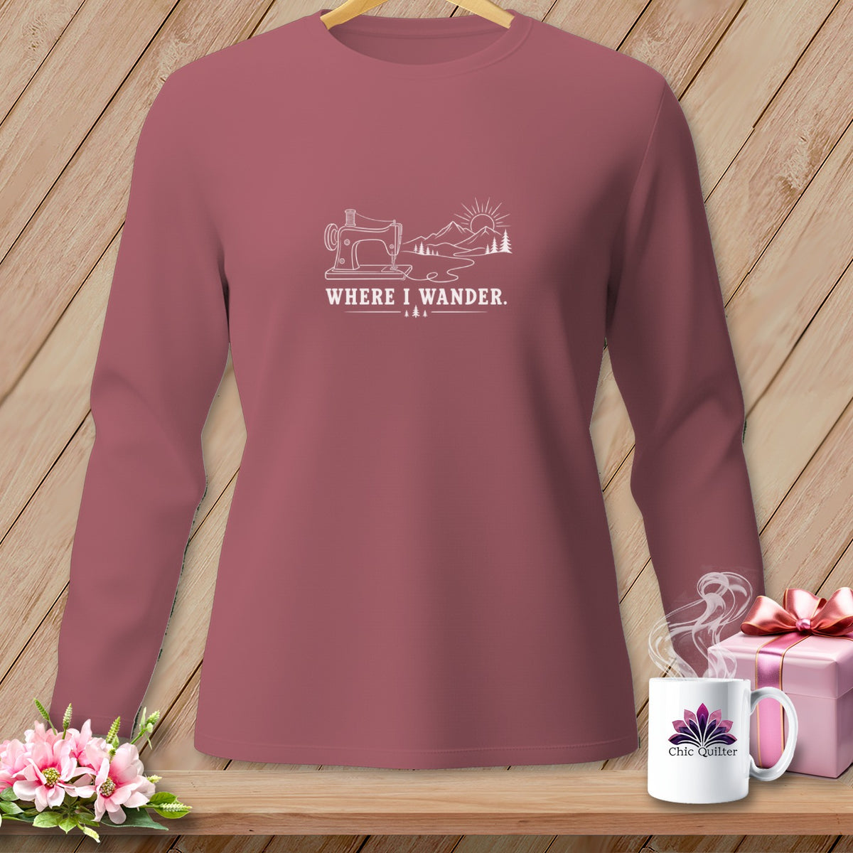Mauve long-sleeved shirt with a white line drawing of a sewing machine, mountains, and sun.