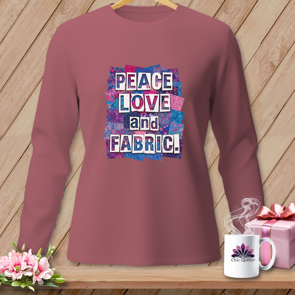 Maroon long-sleeve shirt with "PEACE LOVE and FABRIC" text and floral quilt background.