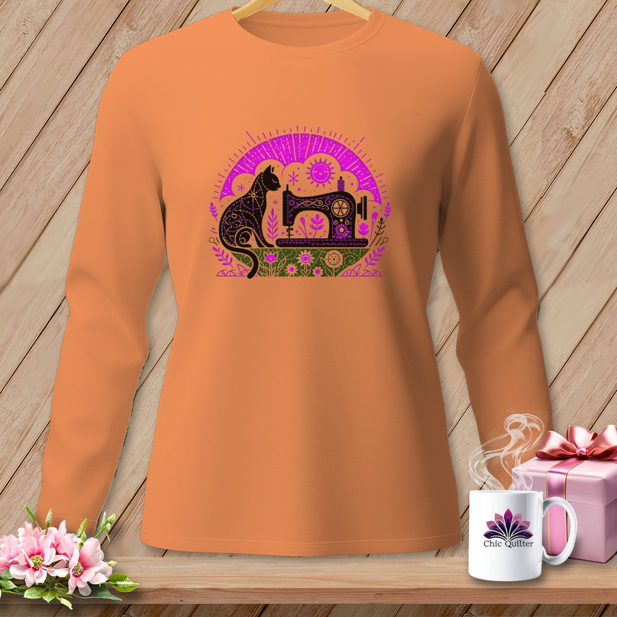 Orange long-sleeve shirt with a black cat and sewing machine graphic.
