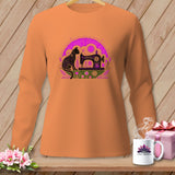 Orange long-sleeve shirt with a black cat and sewing machine graphic.