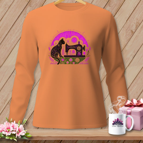 Orange long-sleeve shirt with a black cat and sewing machine graphic.