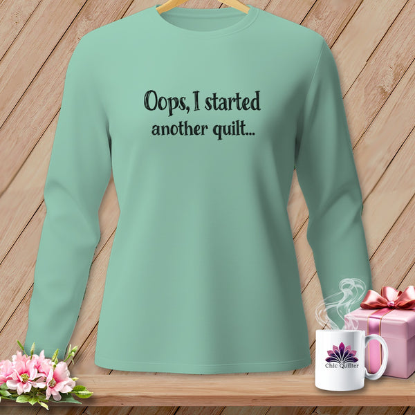 Mint green long-sleeve shirt with "Oops, I started another quilt..." text.