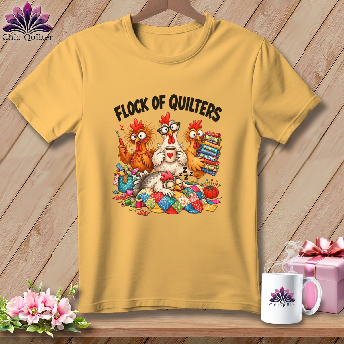 A gold t-shirt displays a cartoon graphic of chickens quilting with text reading Flock of Quilters.