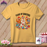 A gold t-shirt displays a cartoon graphic of chickens quilting with text reading Flock of Quilters.