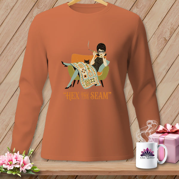 Long-sleeve shirt with a graphic of a woman and cat on a couch and text "HEX THE SEAM".