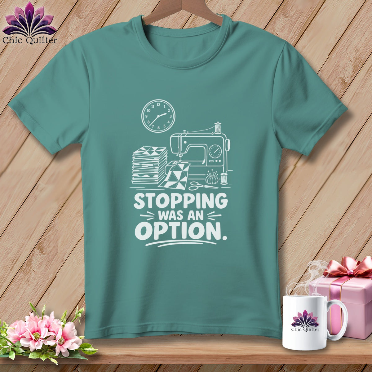 Teal t-shirt with sewing machine graphic and "Stopping was an option" text.