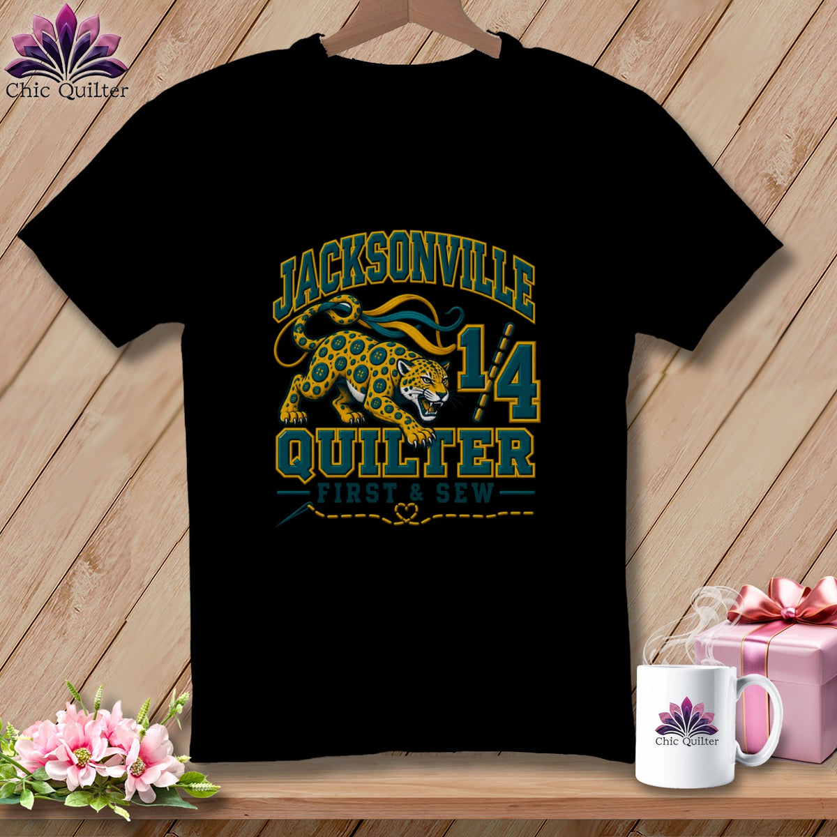Black t-shirt featuring a Jacksonville Quilter graphic with a spotted cat, sewing tools, and text.