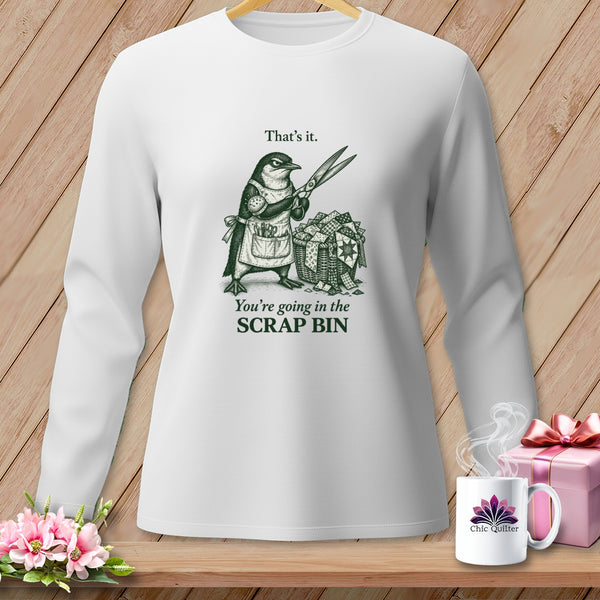 White long-sleeve shirt with a penguin holding scissors above a scrap basket.