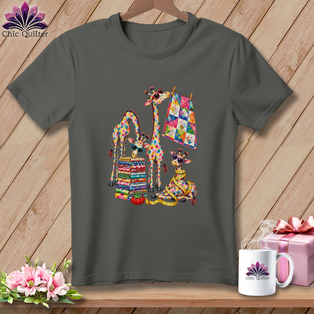 Charcoal gray t-shirt featuring a colorful patchwork design of giraffes with quilts on a wooden background.
