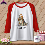 White raglan shirt with red sleeves featuring a basset hound tangled in colorful yarn and text 