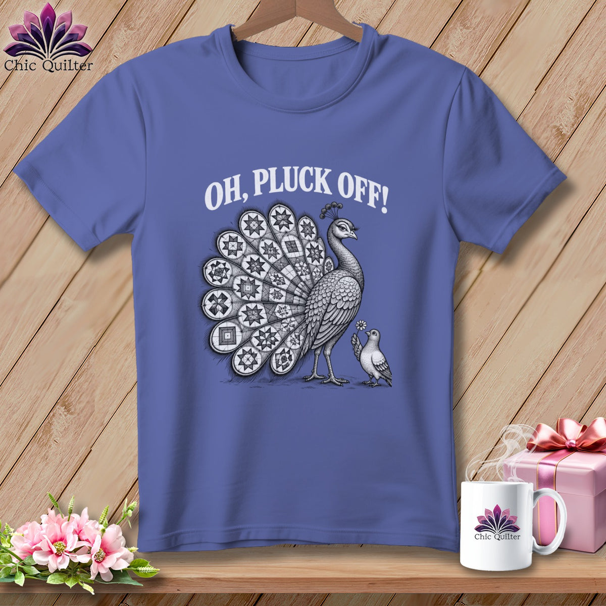 Periwinkle t-shirt with a white graphic of a peacock and pigeon, featuring the text "OH, PLUCK OFF!".