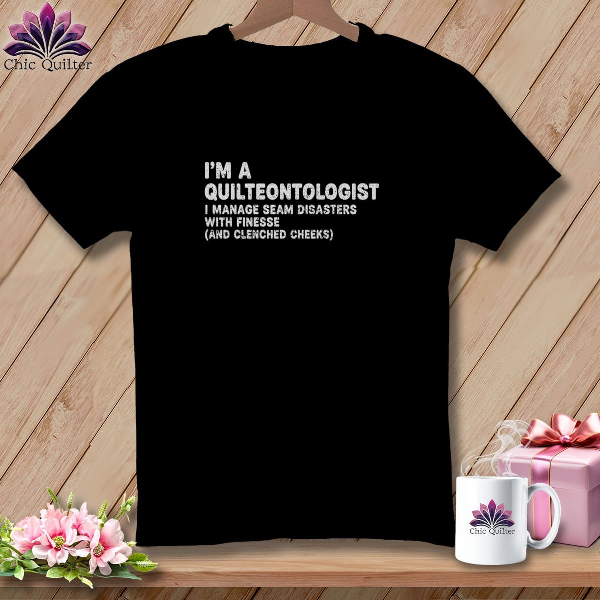 Black t-shirt with white text: "I'M A QUILTEONTOLOGIST I MANAGE SEAM DISASTERS WITH FINESSE (AND CLENCHED CHEEKS)".