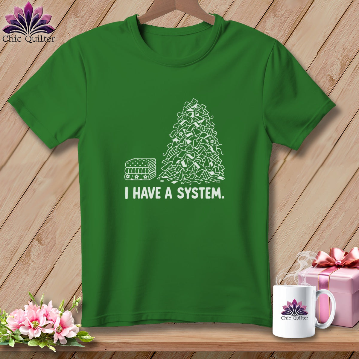 Green t-shirt with a stack of fabric scraps and the text "I HAVE A SYSTEM."