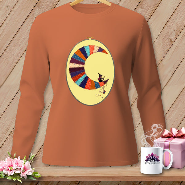 Long-sleeve burnt orange t-shirt with a crescent moon quilt design and a witch riding a broom.