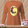 Long-sleeve burnt orange t-shirt with a crescent moon quilt design and a witch riding a broom.