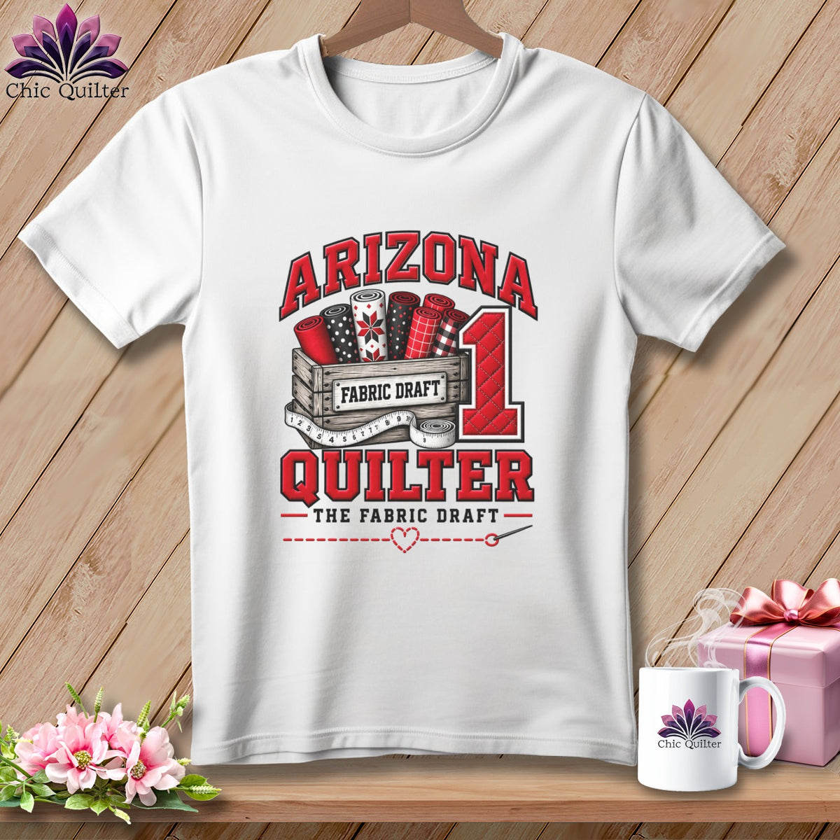 A white t-shirt features a graphic with a crate of fabric rolls and text reading Arizona Quilter.