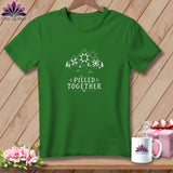 Green t-shirt with a mountain scene, sun, and text 