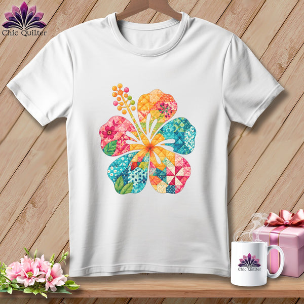 A white short-sleeved t-shirt features a colorful quilted hibiscus flower graphic centered on the chest.