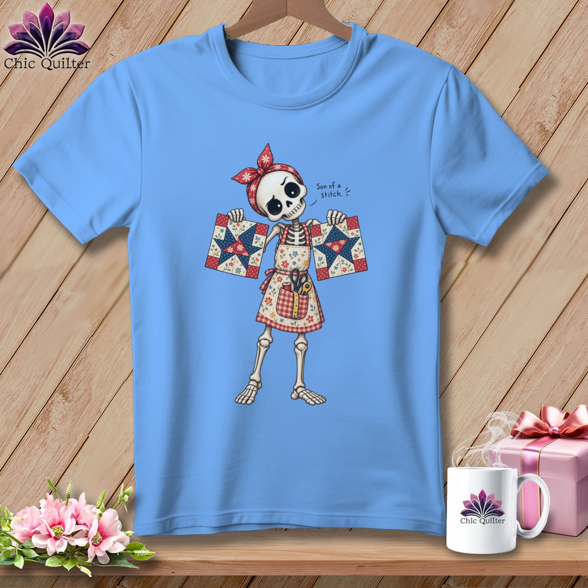 Skeleton wearing apron and bandana holding quilt squares, text "Son of a stitch".