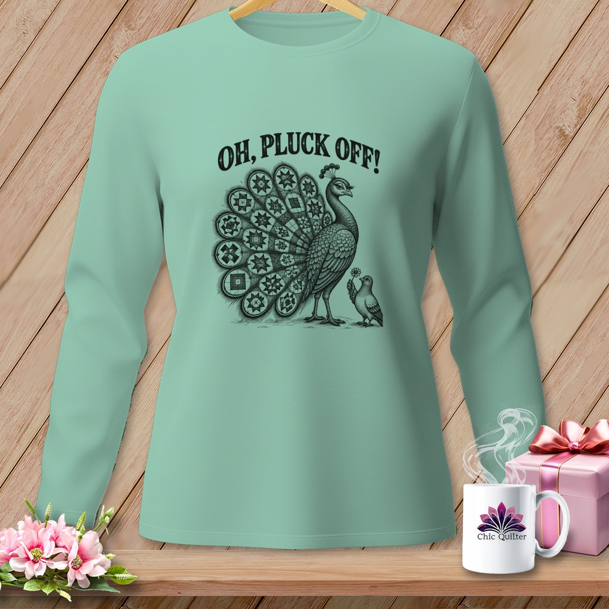 Mint green long-sleeve shirt featuring a peacock graphic with the text OH PLUCK OFF!