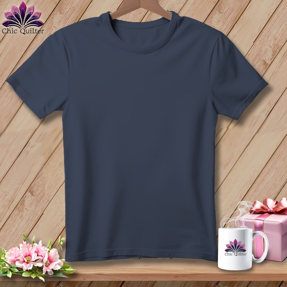 Dark blue t-shirt displayed with a gift, flowers, and a mug.