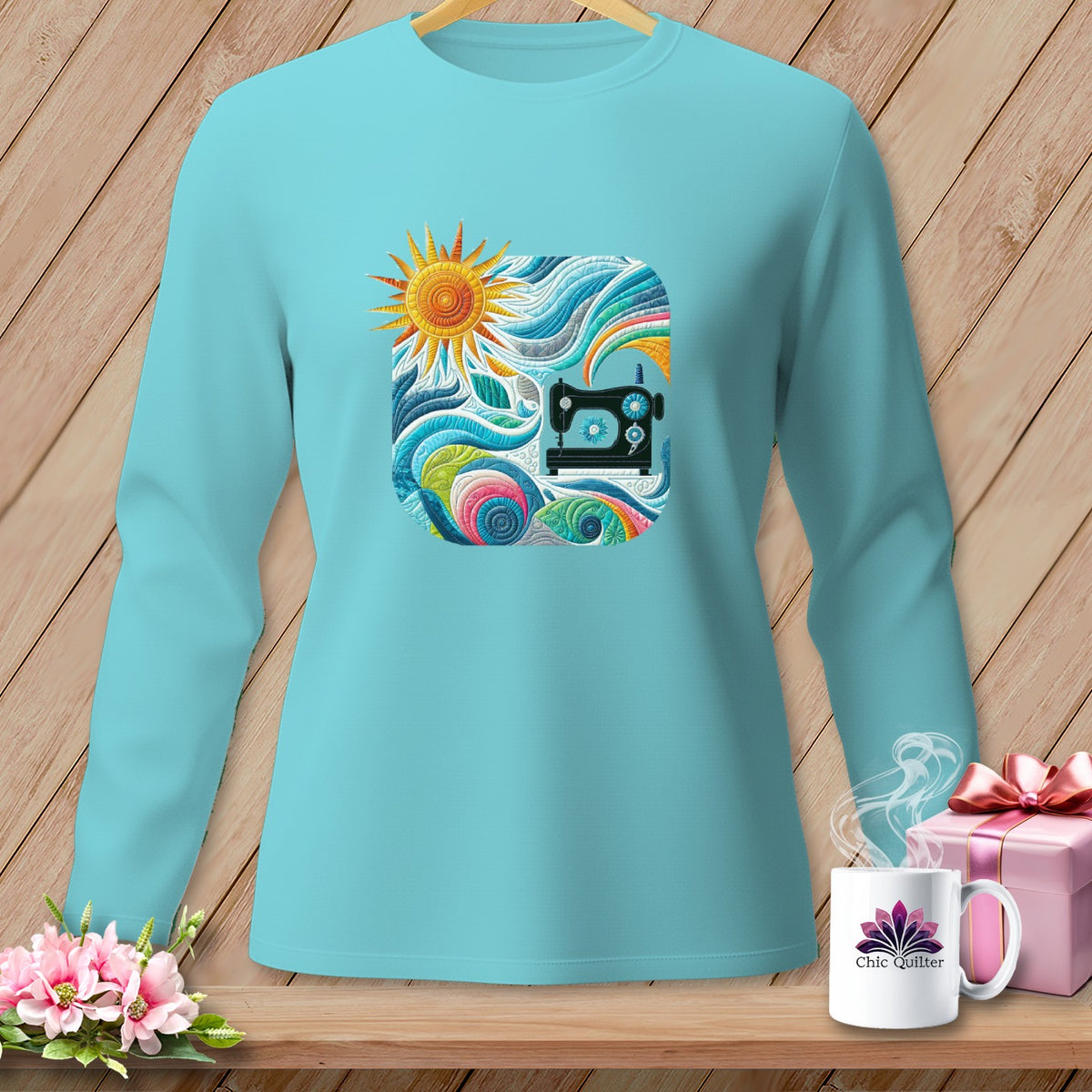 Teal long-sleeve shirt with a square graphic of a sewing machine and sun.