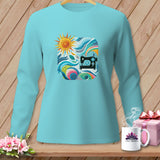 Teal long-sleeve shirt with a square graphic of a sewing machine and sun.