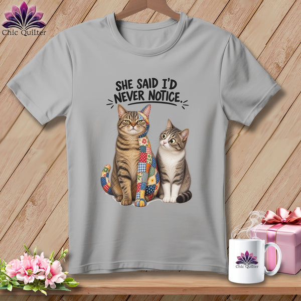 Two cats with patchwork quilting on one cat, under text "She Said I'd Never Notice".