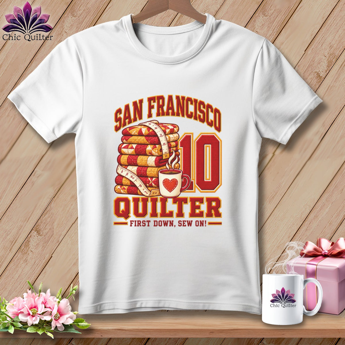White t-shirt featuring a San Francisco Quilter graphic with a folded quilt stack and mug.