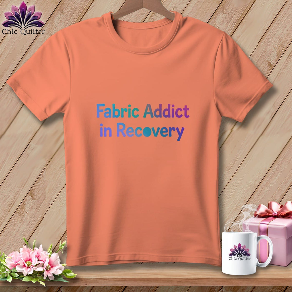 Coral t-shirt with "Fabric Addict in Recovery" text, pink gift, and mug.