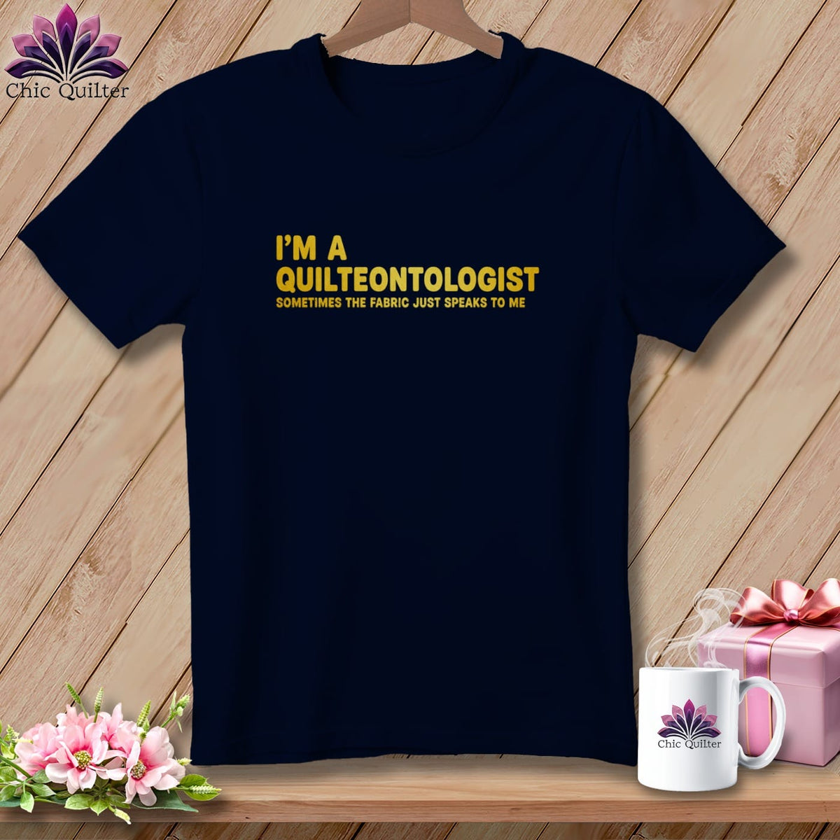 Dark navy t-shirt with "I'm a Quilteontologist Sometimes the fabric just speaks to me" text.