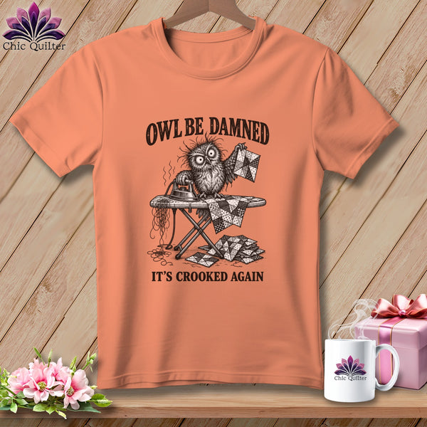 T-shirt with an owl ironing a quilt, text reads "OWL BE DAMNED IT'S CROOKED AGAIN".