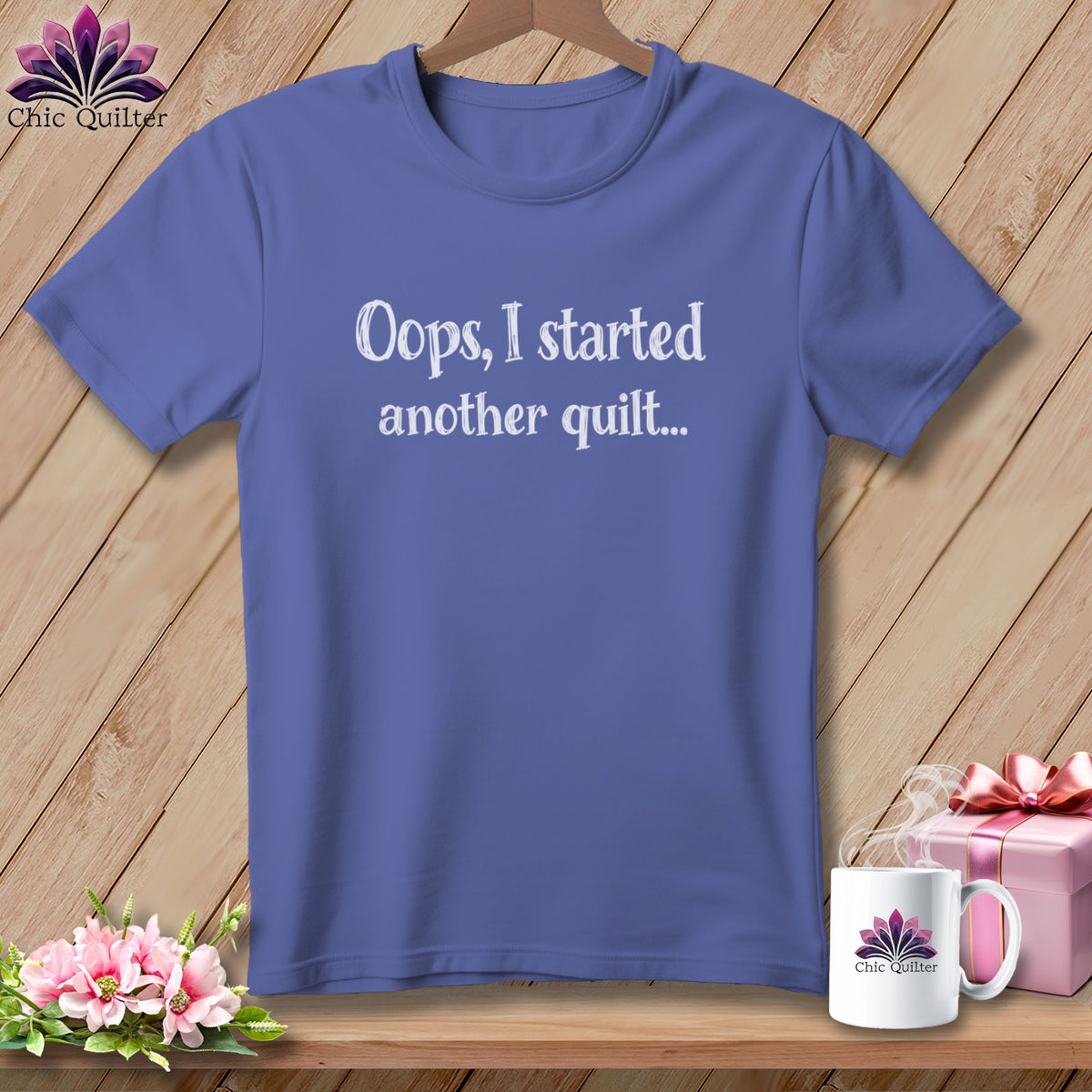 Periwinkle t-shirt with "Oops, I started another quilt..." text.