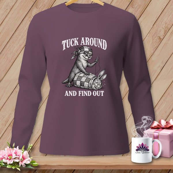 Plum long-sleeve shirt with a vintage graphic of an otter tucking a rabbit into a quilt.