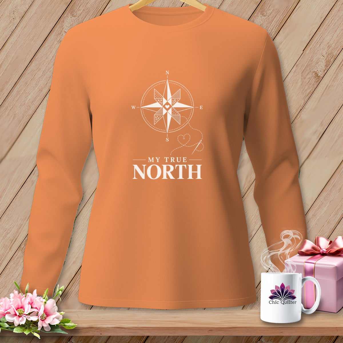 Orange long sleeve shirt with compass graphic and "My True North" text.