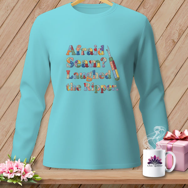 Teal long-sleeve shirt with "Afraid Seam? Laughed the Ripper." text and sewing tool graphic.