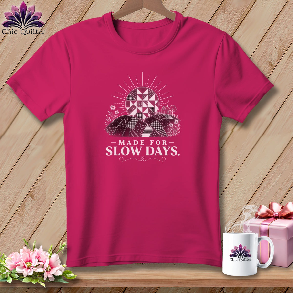Magenta t-shirt with quilting-inspired sun, hills, and the text "Made for Slow Days."