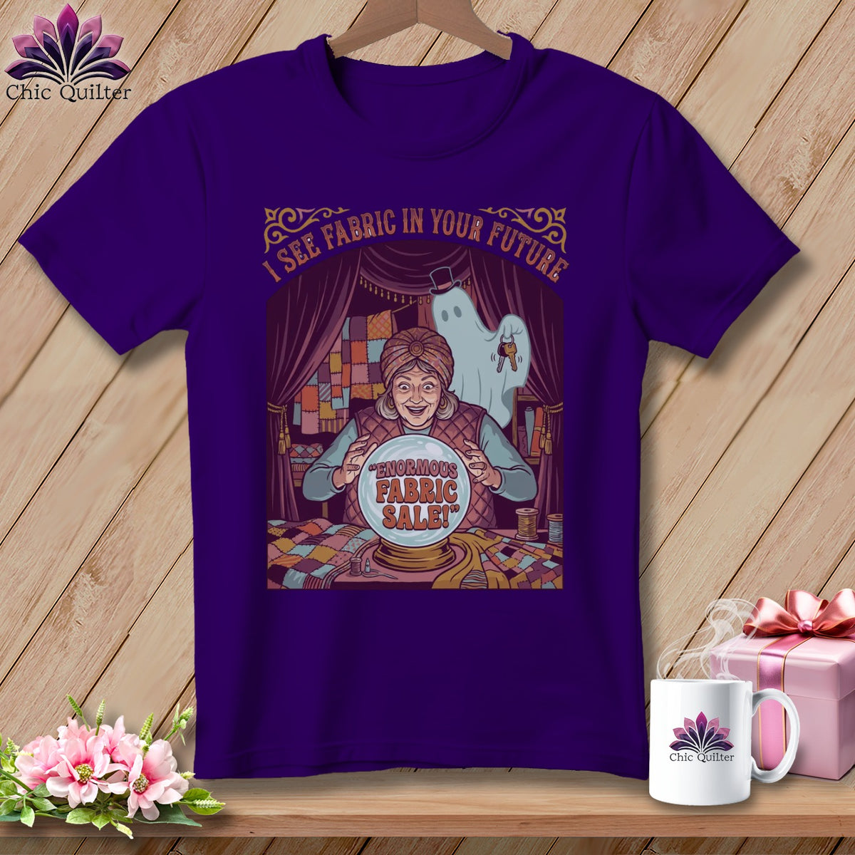 Purple t-shirt with a fortune teller, ghost, and crystal ball graphic reading "Enormous Fabric Sale!"